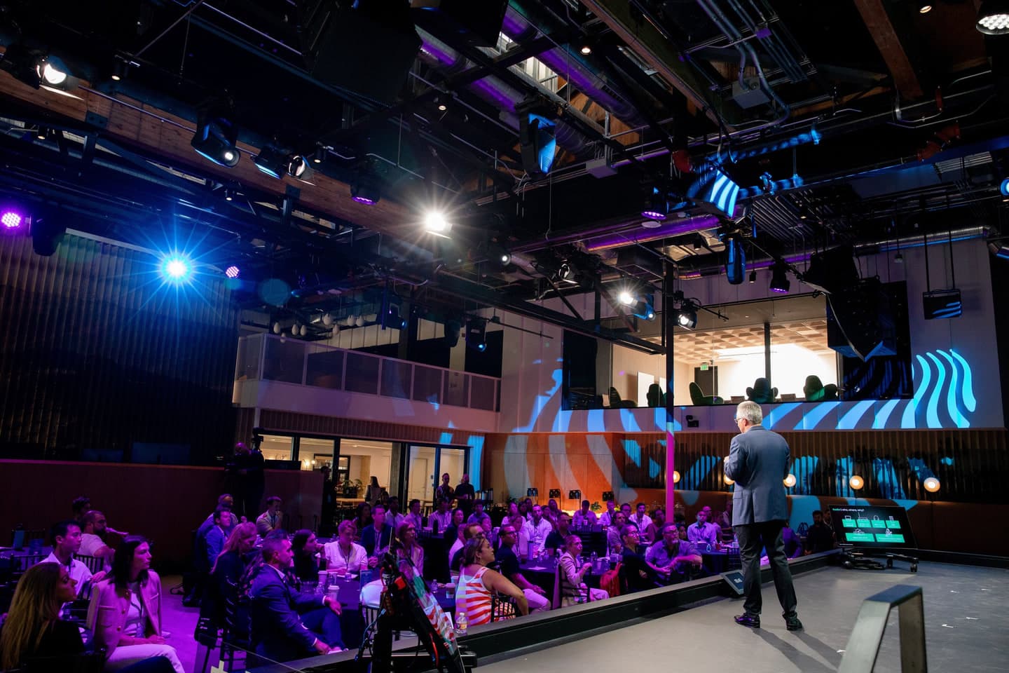 Wide view of the main stage and seated audience